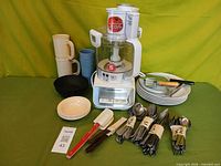 Group shot showing food processor, plates, bowls, tumblers, flatware bundles and utensils