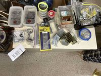Overview of tabletop with packaged hardware, loose nails, wire spool