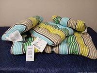 Five striped outdoor seat cushions with tags