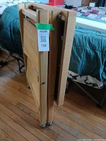 Cart folded flat showing compact profile and casters