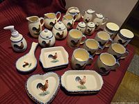 Full lot overview showing pitchers, mugs, dishes, spoon rest, soap dispenser and canisters