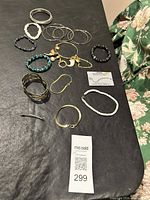 Bracelets and bangles spread on black surface