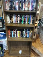 Bookcase upper shelves filled with VHS tapes