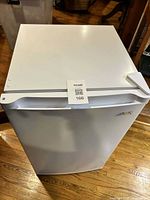 Front and top view of white Arctic King upright freezer