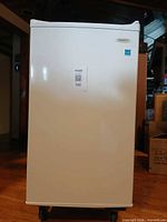 Front view of white Arctic King mini upright freezer with Energy Star sticker