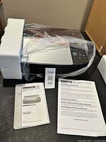 Air purifier inside packaging with foam protectors and user manual