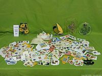 Wide view of loose stamps spread out with clear plastic box in background