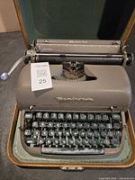 Overall view of Remington Quiet-Riter typewriter in case