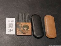 Wooden hair pick, black and tan eyewear cases