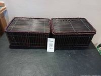 Two closed wicker storage boxes side by side