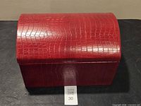 Closed red faux crocodile chest style box