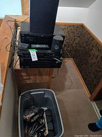 Stacked stereo components with speakers and tote of cables