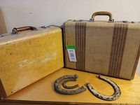 Exterior view of both suitcases and three horseshoes
