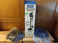Boxed Burke sump pump with two bagged discharge hoses