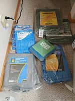 Group shot showing all packaged tarps on floor