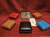 All six travel clocks arranged on fabric backdrop