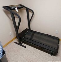 Treadmill standing, console and frame visible