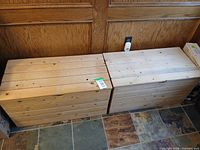 Two pine storage boxes with lids closed, side by side