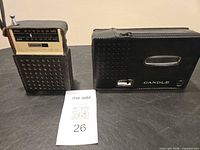 Both devices in their cases, Candle case showing brand label, Philco radio partially inserted in case