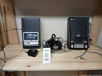 Two cassette recorders and microphones on shelf
