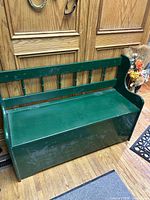 Front view of green wooden storage bench