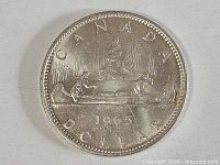 Reverse view showing CANADA DOLLAR 1965 voyageur design