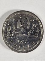 Full view of reverse with canoe design and date 1977