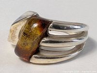 Side view of sterling silver ring showing tiger’s eye cabochon and split shank design