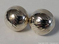 Front view of both sterling silver etched ball earrings