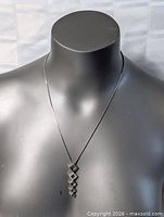 Full view of necklace on bust form showing chain length and pendant drop