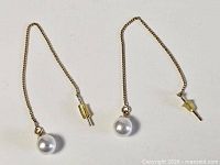 Full view of both sterling silver threader earrings showing chains, pearls and stoppers