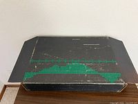 Closed outer box showing wear and graphics