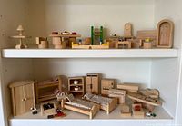 Full view of both shelves showing the majority of wooden furniture pieces