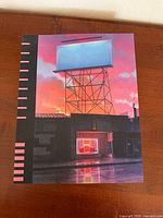 Front cover showing building with blank billboard at dusk