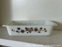 Side view of white rectangular Pyrex casserole showing full Golden Pine pattern