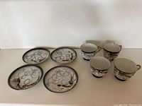 Set overview showing three saucers and four cups