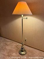 Full view of floor lamp with shade illuminated