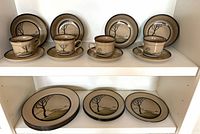 Full view of set on two shelves showing cups, saucers, side plates and dinner plates
