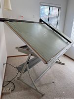 Table angled showing frame, parallel bar, power cord