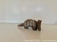 Left side profile of wooden armadillo figurine