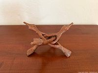 Full view of folded wooden cobra tripod stand showing three legs interlocked
