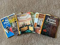 All six renovation books fanned out on carpet
