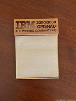 Front view of IBM promotional wooden notepad with attached memo pad