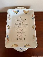 Top view of rectangular casserole dish showing rooster motifs and French script