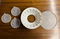 Set showing ring mold, lid, three inserts with star, heart and tulip designs