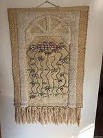 Full view of hanging showing design, borders, fringe and hanger