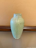 Full front view of turquoise-green Van Briggle vase
