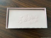 top view of boxed set showing embossed rose design