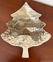 Front of tree-shaped relish dish showing winter village scene