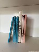 Seven books standing showing spines
